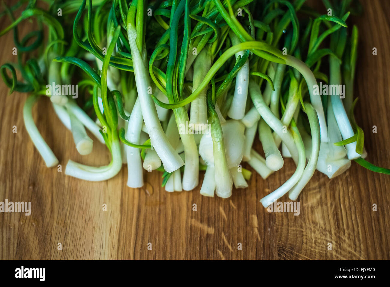 The green onion on brown wood background Stock Photo - Alamy