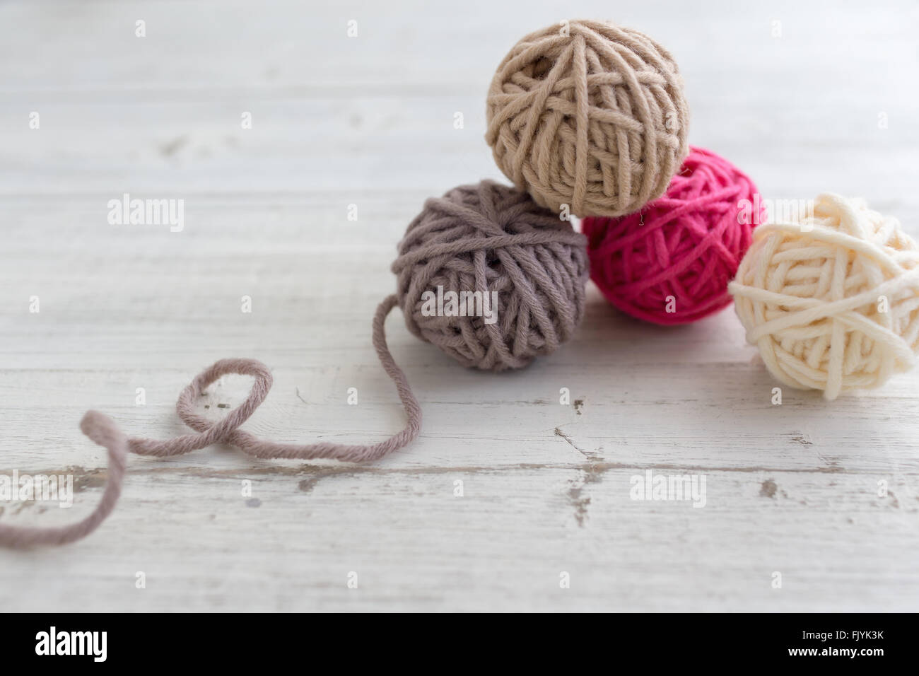 Balls of wool on wooden background Stock Photo