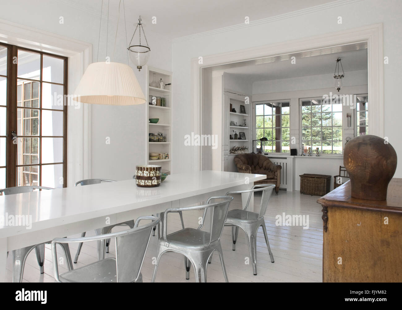 A refurbished open plan historic Georgian house with white walls and floors a holiday home furnished to a high standard Stock Photo