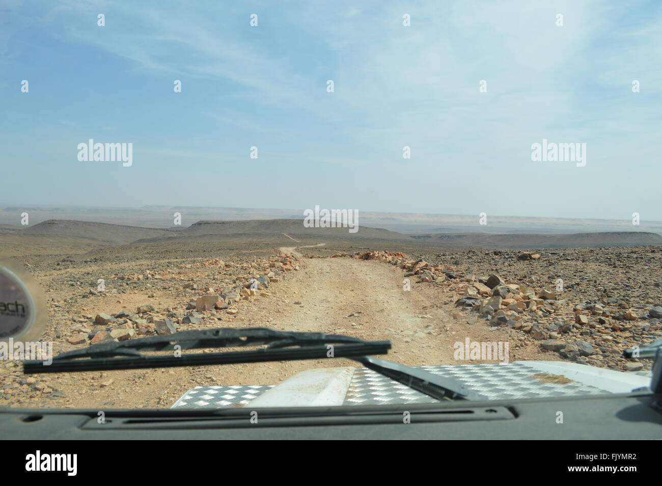 Driving Land Rover Defender in Sahara Stock Photo