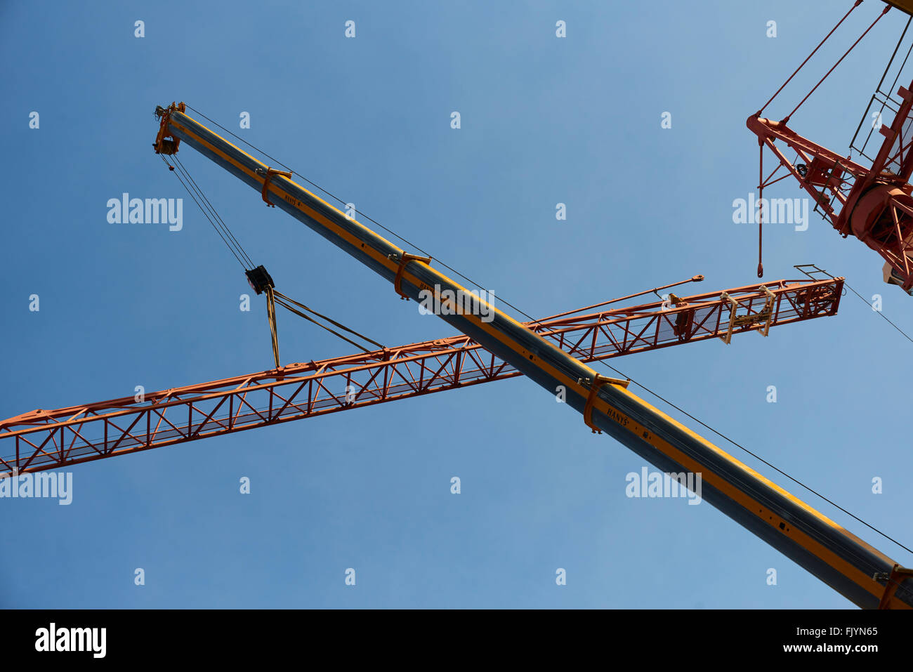 Construction worker dismantling tower crane Stock Photo