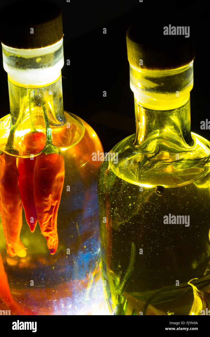 A pair of clear glass bottles filled with Olive Oil and flavoured with