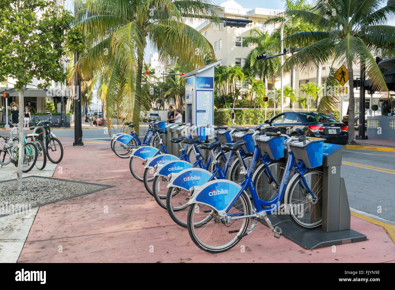 Bicycles parked in a row at city bike station on corner Collins Avenue and 14th Street in South Beach district of Miami Beach, F Stock Photo