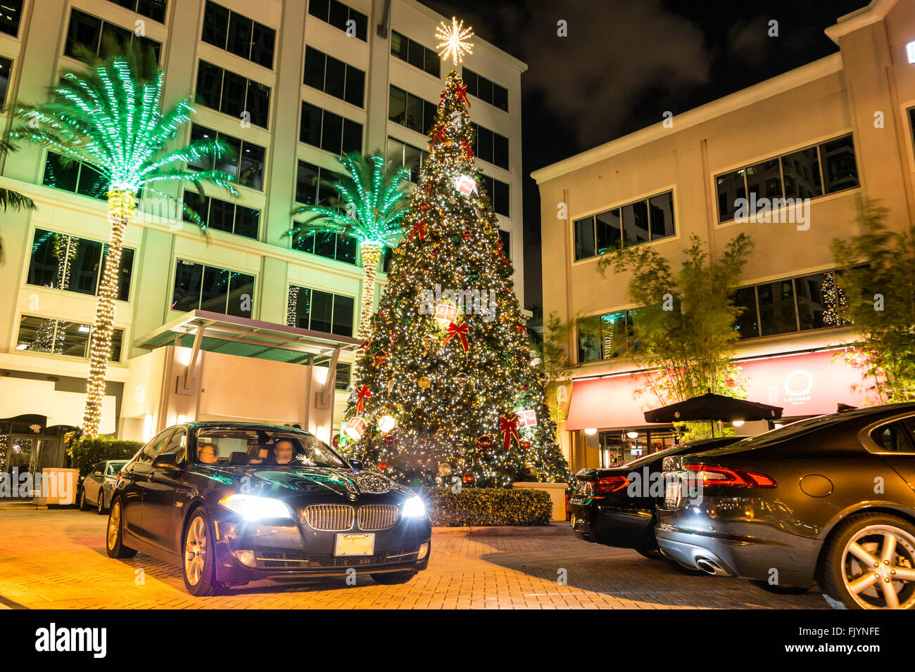 Night view of hotel entrance, christmas tree and cars on Las Olas Boulevard in Fort Lauderdale, Florida, USA Stock Photo