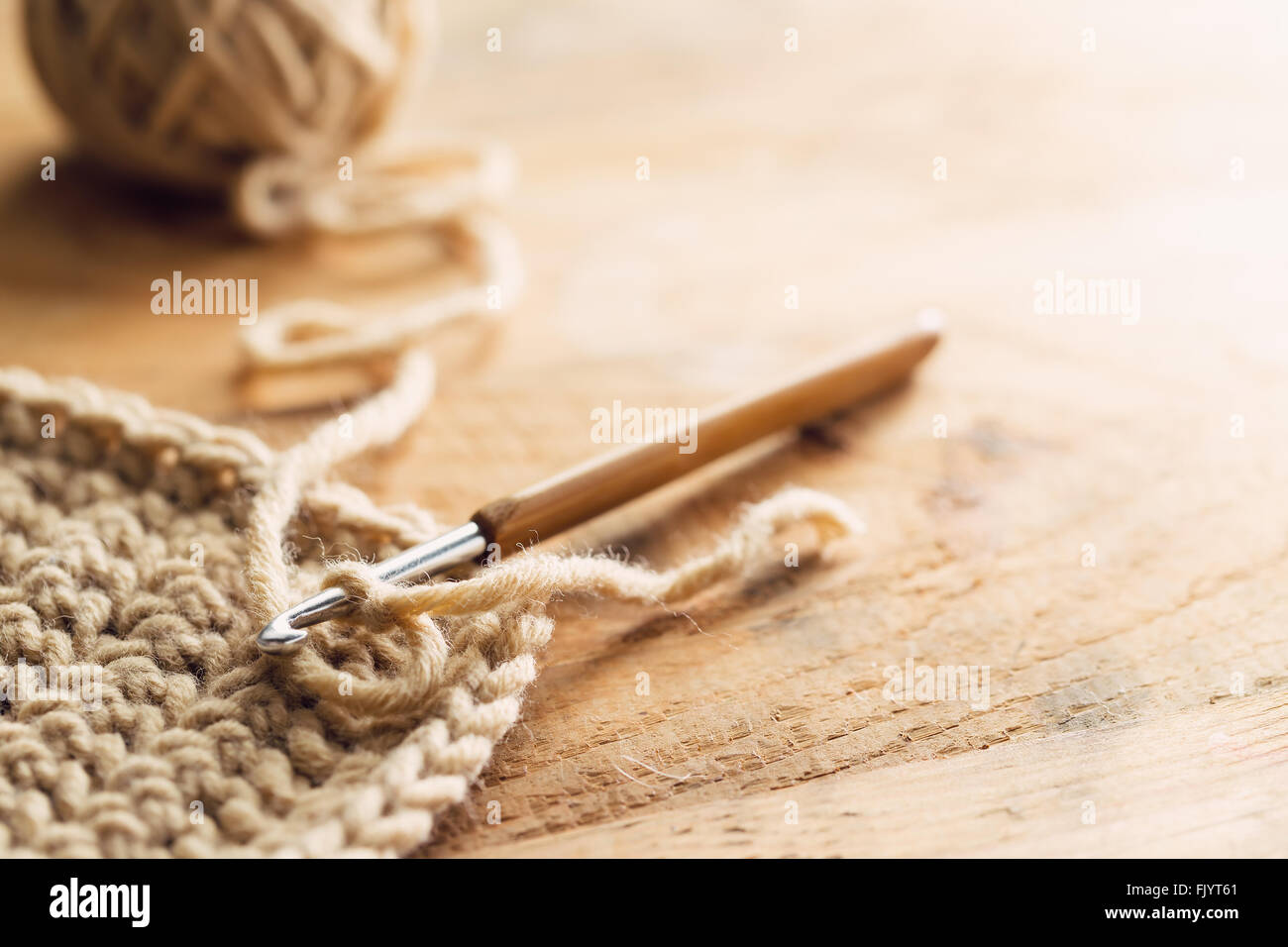 Crochet hook on wooden background Stock Photo