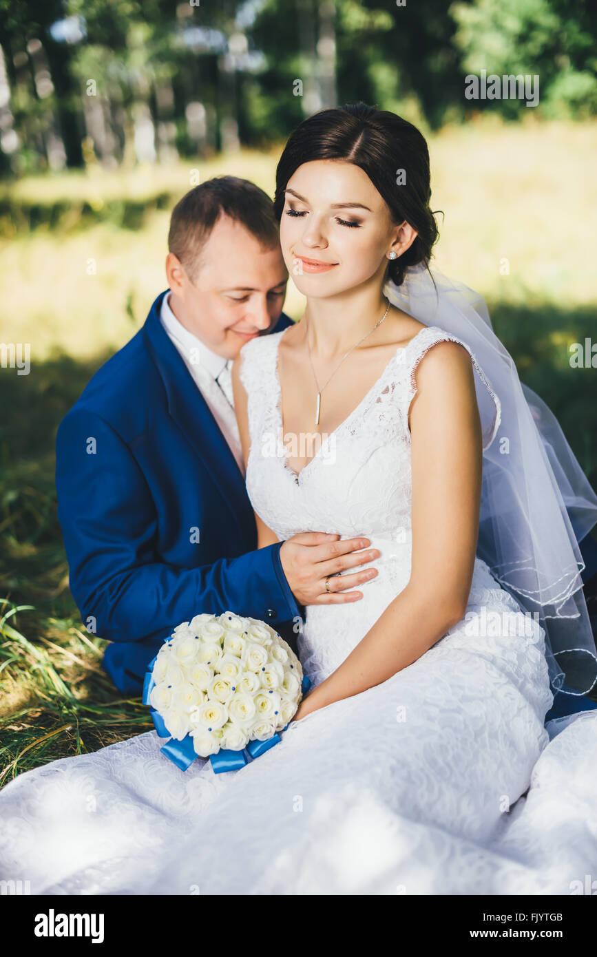 the bride and groom sitting Stock Photo - Alamy