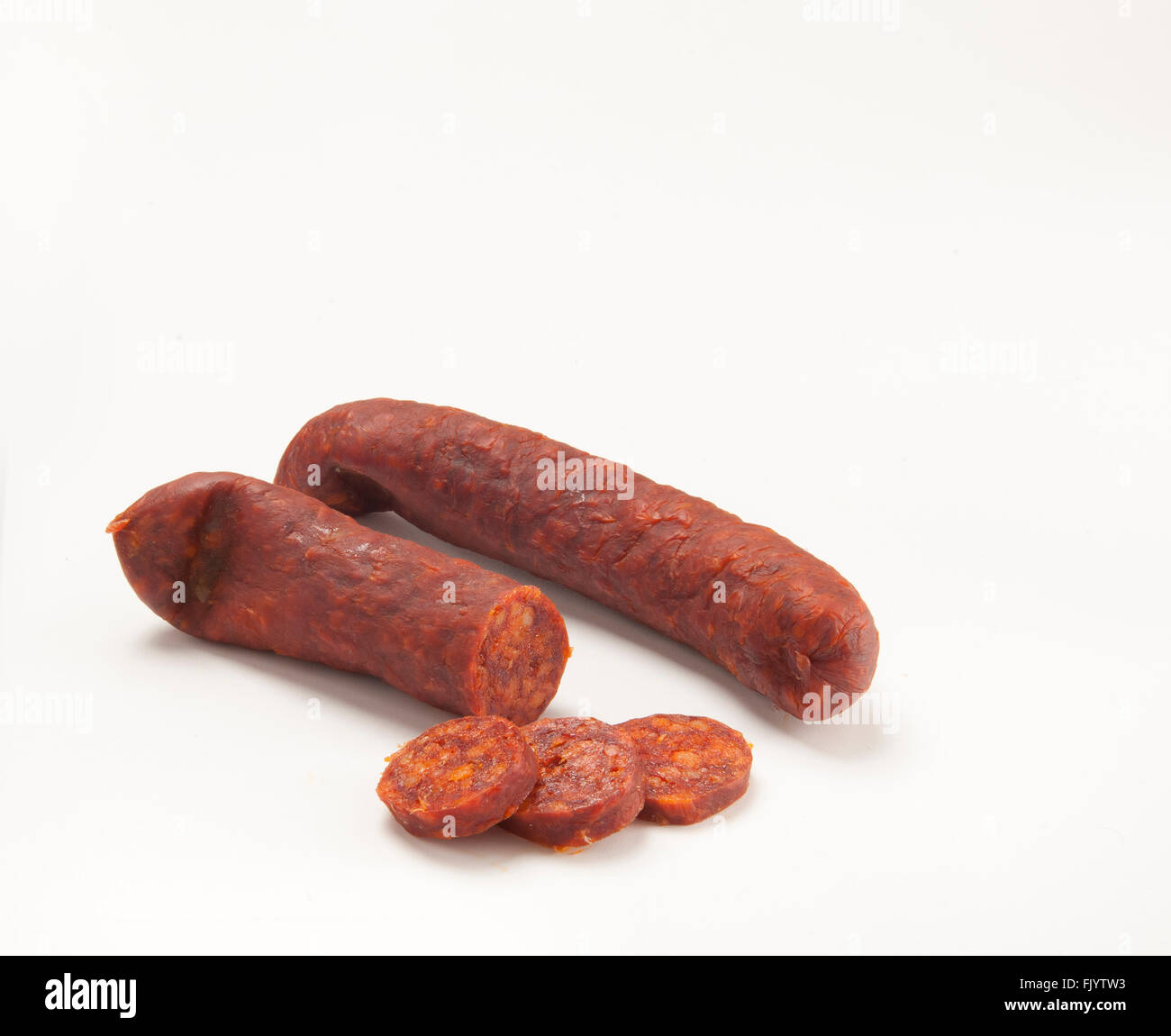 Chopped halved and whole Mangalica long Hungarian sausage made from the meat of the curly-coated fat Mangalica pig and Stock Photo