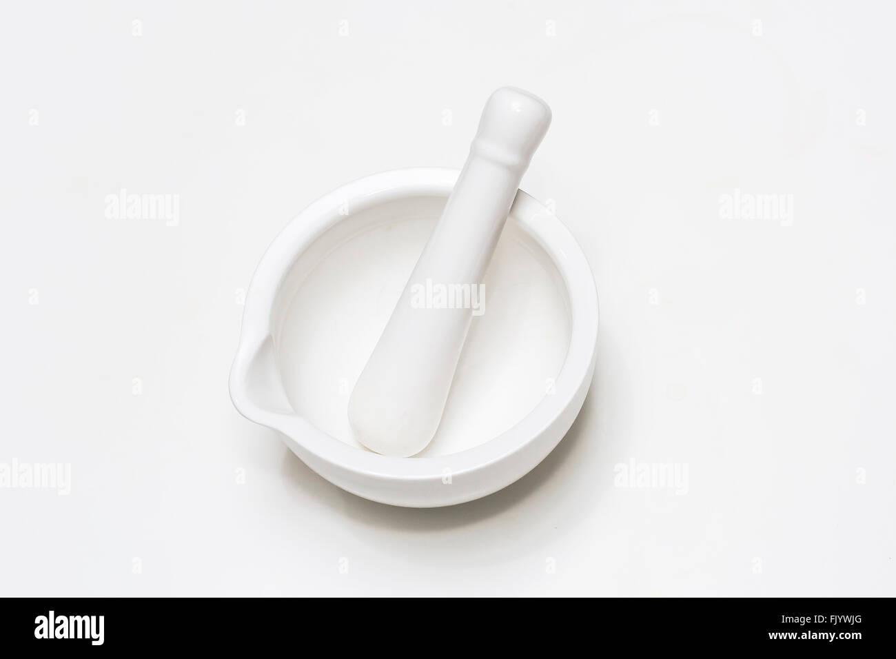 White ceramic mortar and pestle isolated on white background Stock