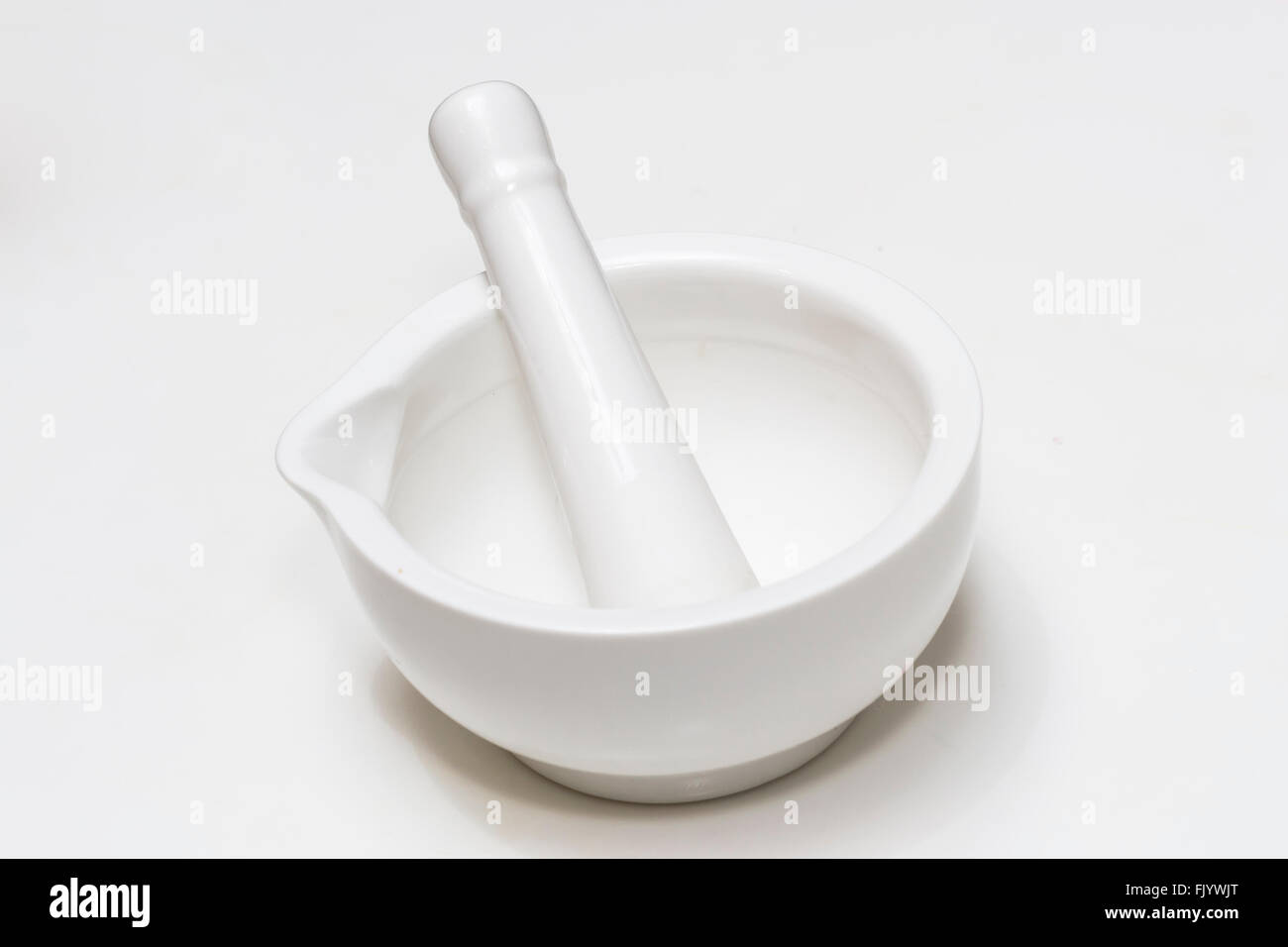 White ceramic mortar and pestle isolated on white background Stock