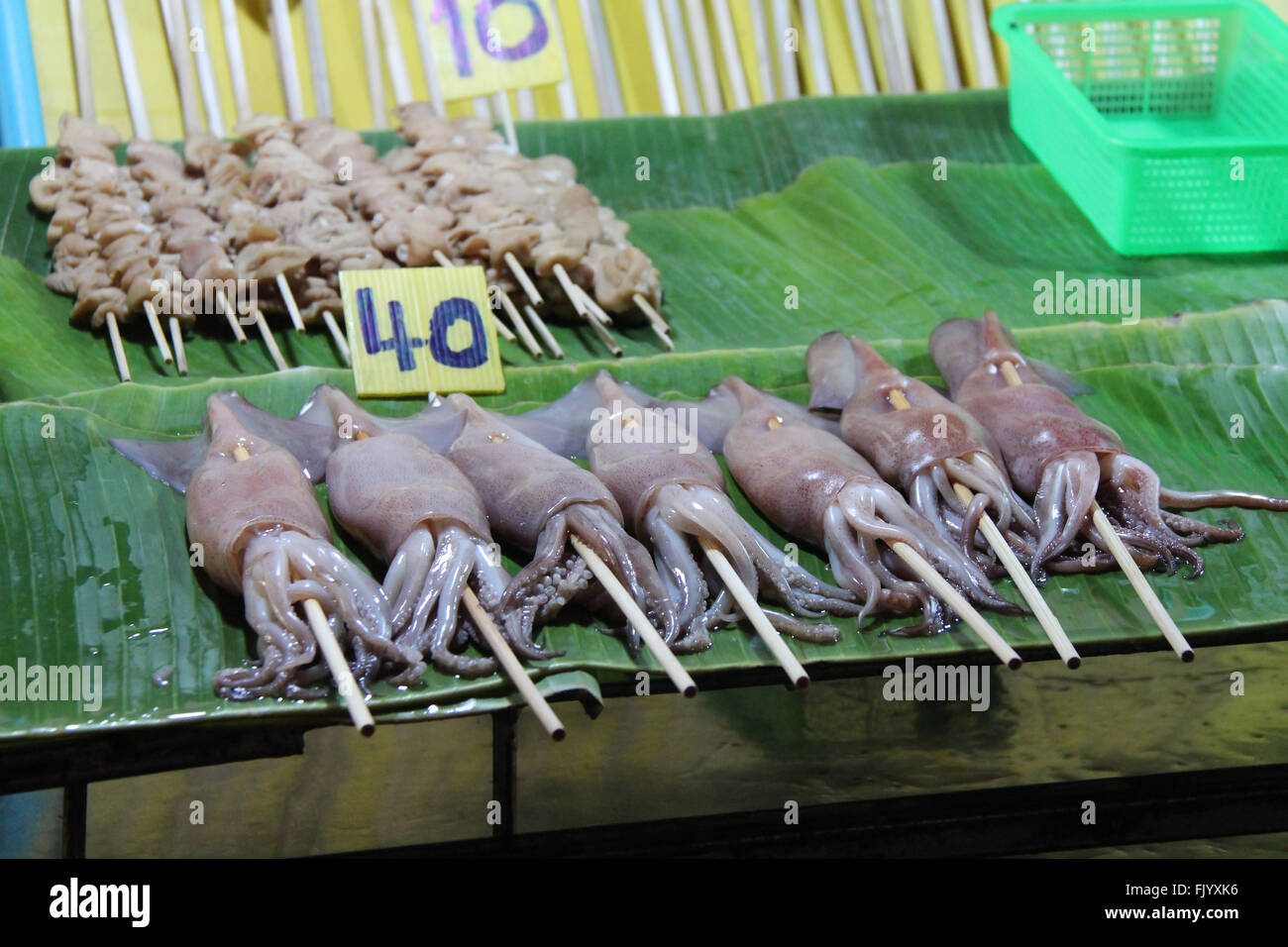 Dead cuttlefishes are sold on a stall at the night market of Chiang Mai (Thailand). Stock Photo