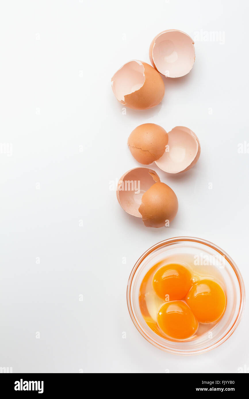 Broken eggshells with egg yolks in glass bowl Stock Photo Alamy