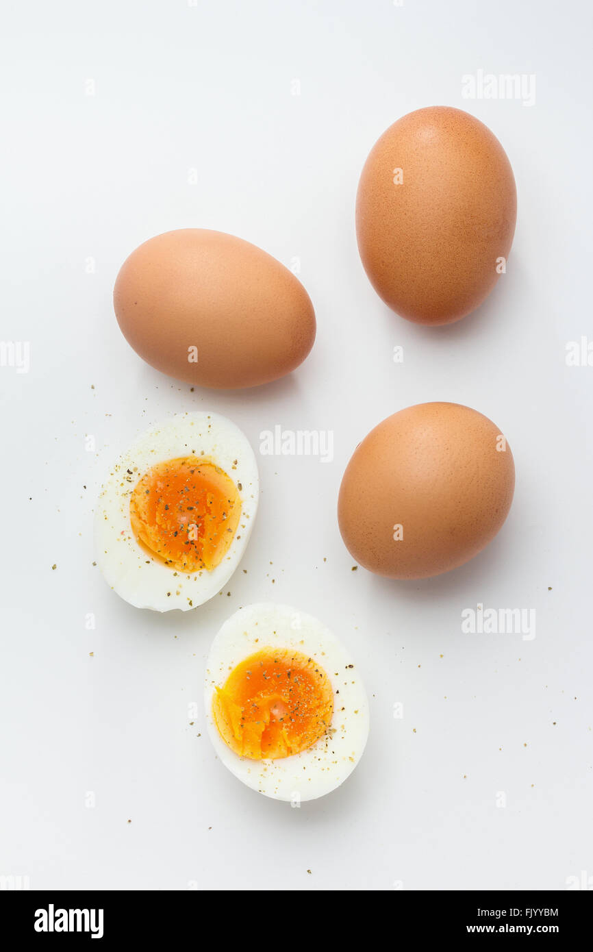Hard boiled egg halves with whole eggs Stock Photo