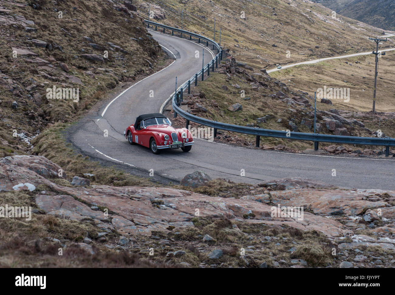 A 1955 Jaguar XK140 OTS on the Bealach na Ba in Applecross Scotland Stock Photo