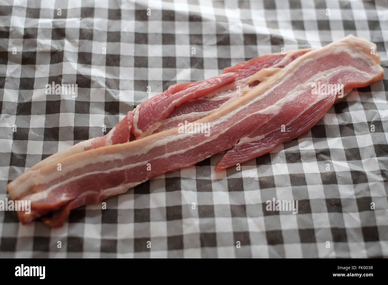 Slices of smoked streaky bacon Stock Photo
