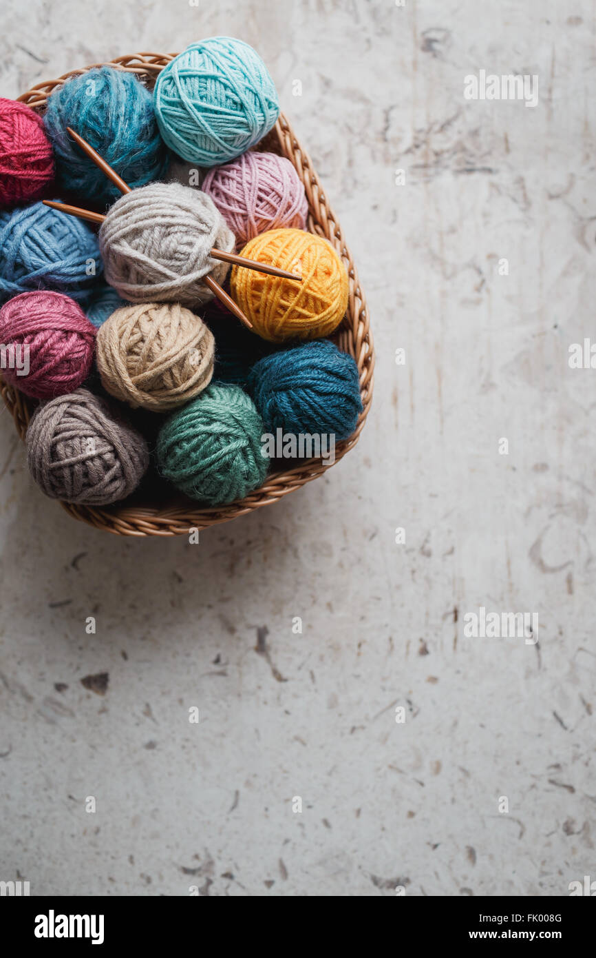 Knitting needles and yarn balls in basket Stock Photo Alamy
