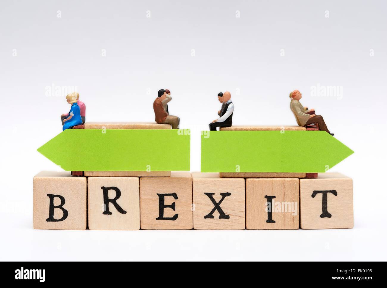 Miniature people sitting on top of the word Brexit with opposing green arrows decision concept Stock Photo