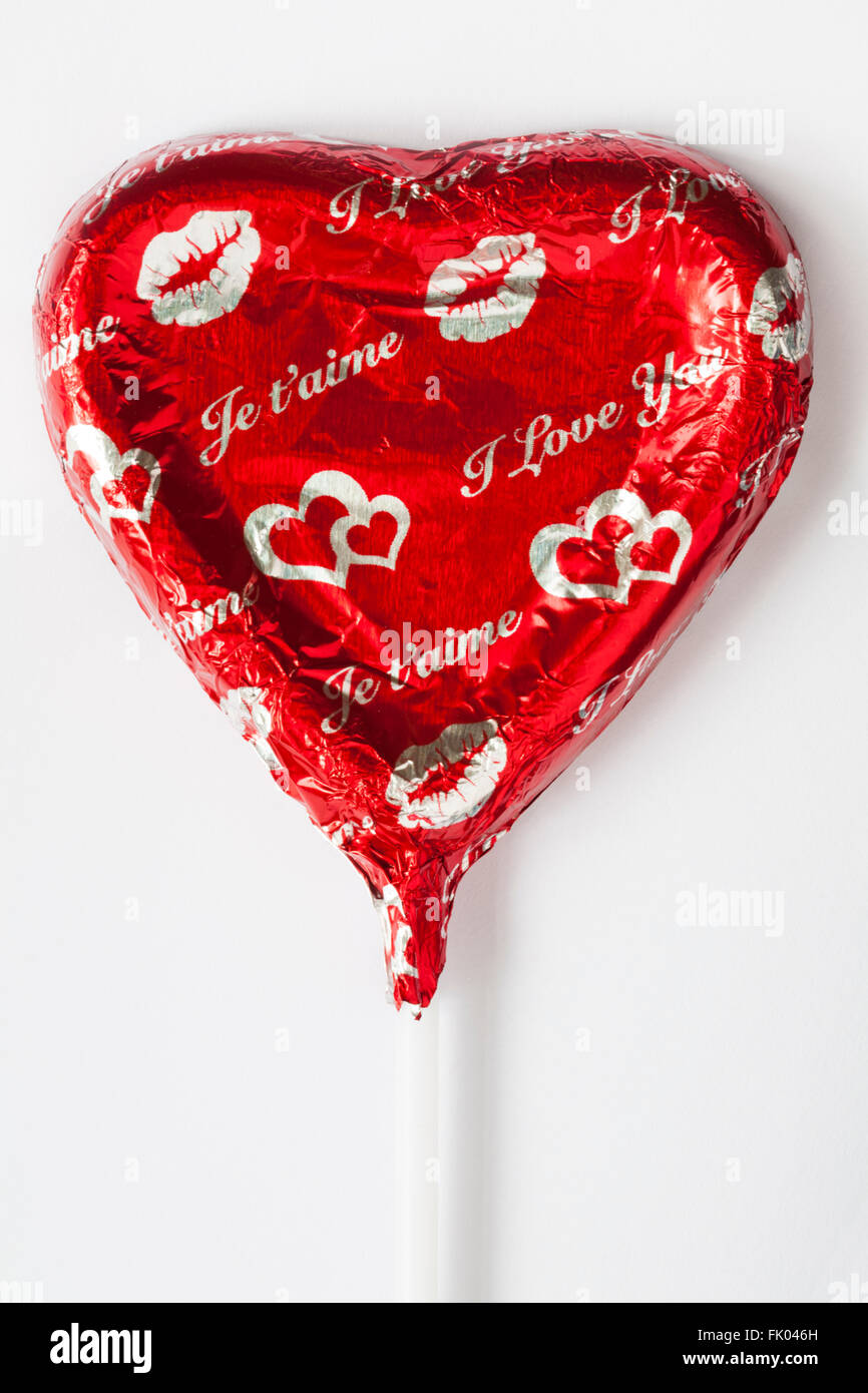 I love you je t'aime solid milk chocolate heart shaped lolly for Valentine's day on white background  - ideal for Valentines day, Valentine day Stock Photo