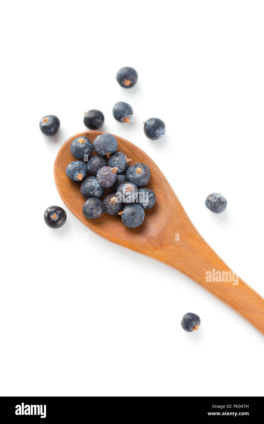 Wooden spoon with seeds of juniper Stock Photo