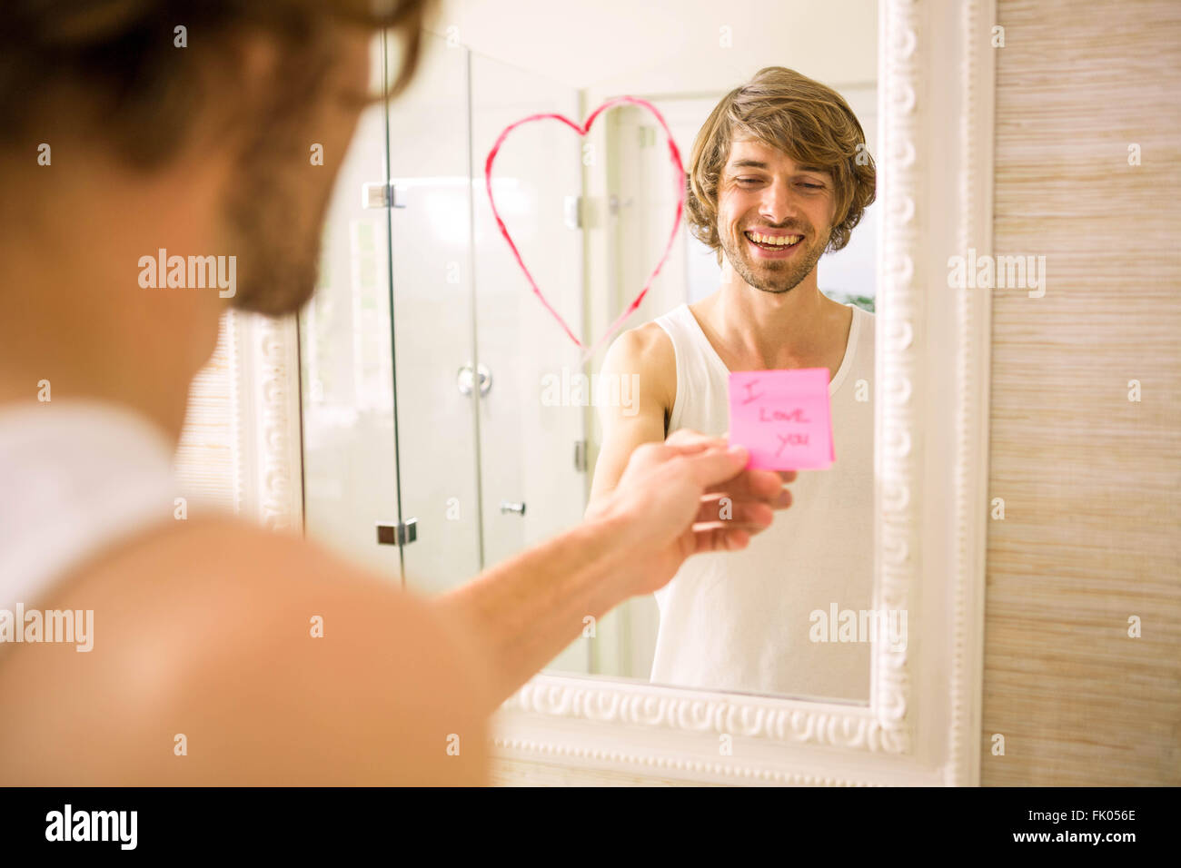 Boyfriend discovering a love message on the mirror Stock Photo