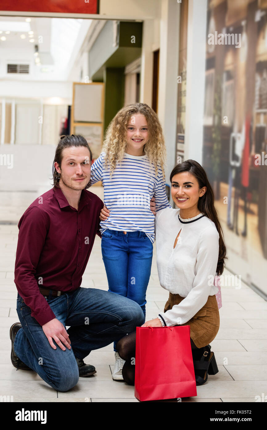 Portrait of happy family in shopping mall Stock Photo