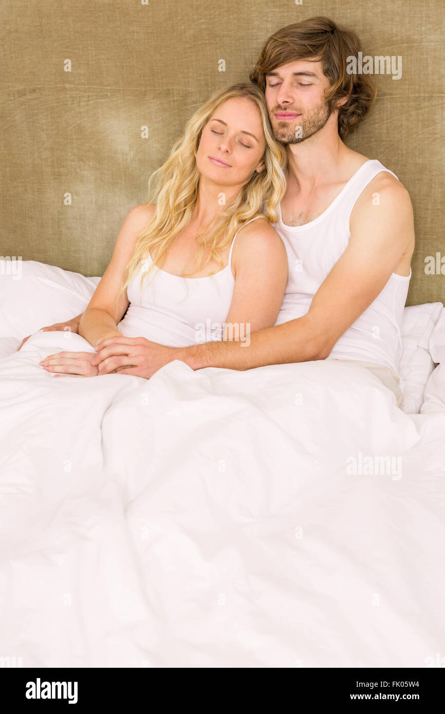Cute couple cuddling in bed Stock Photo Alamy