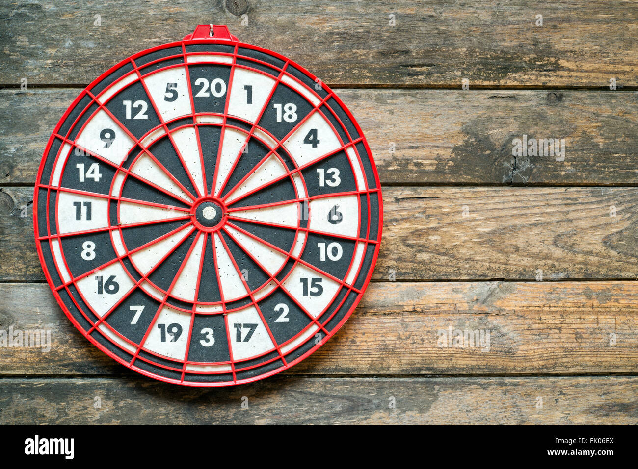Target dartboard on a wooden wall with no hits Stock Photo
