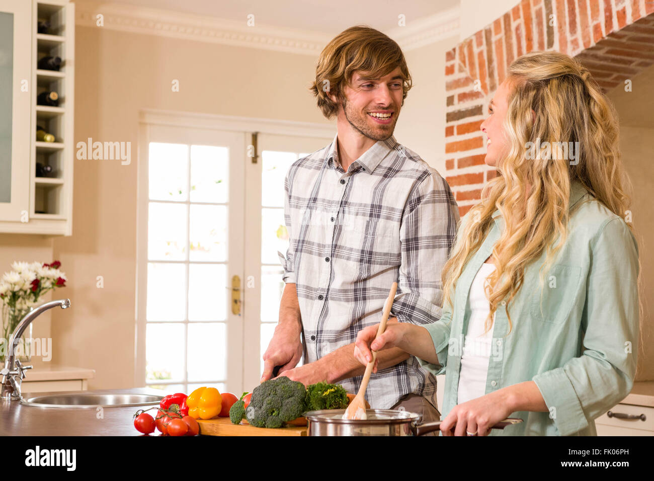 Cute couple cooking together Stock Photo