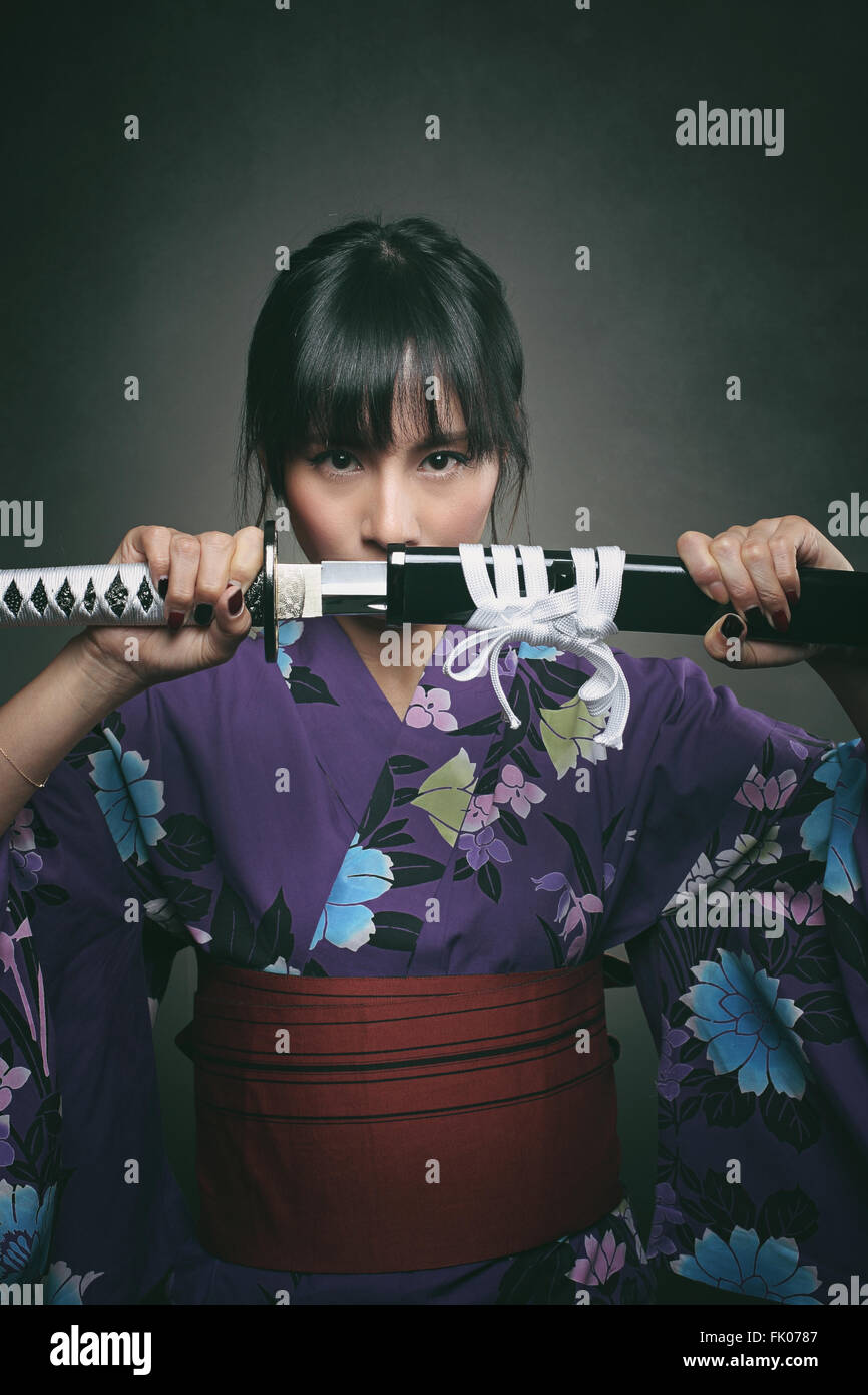 Japanese woman with samurai sword. Power and revenge Stock Photo