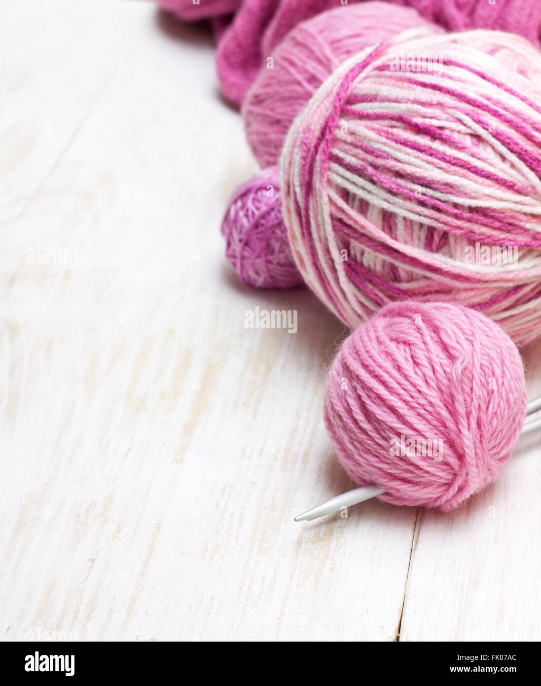 balls of pink yarn on a wooden background Stock Photo