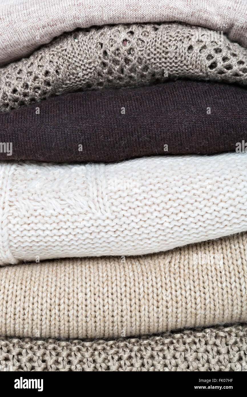stack of brown woolen knitted sweaters, full frame Stock Photo