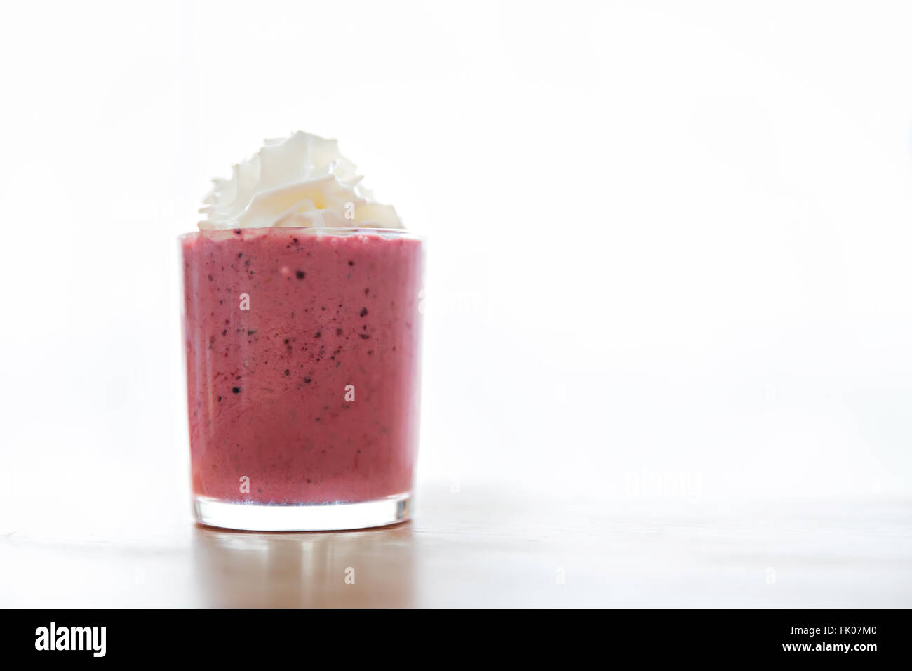 strawberry and raspberry smoothie in transparent glass Stock Photo