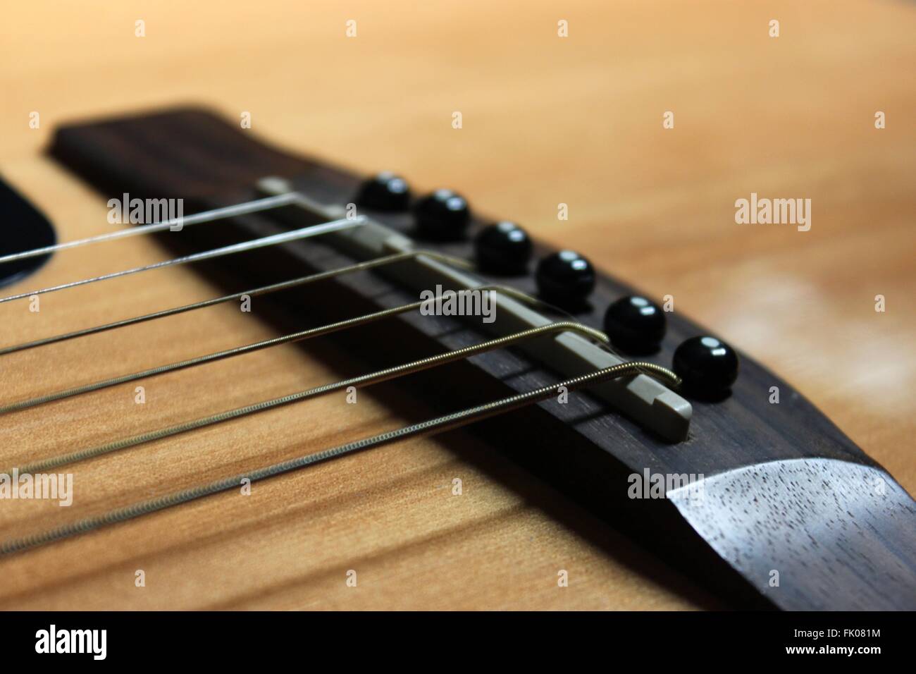 close up view of acoustic guitar strings and bridge Stock Photo - Alamy
