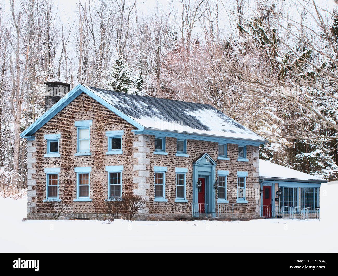 brick and stone home in wintertime Stock Photo