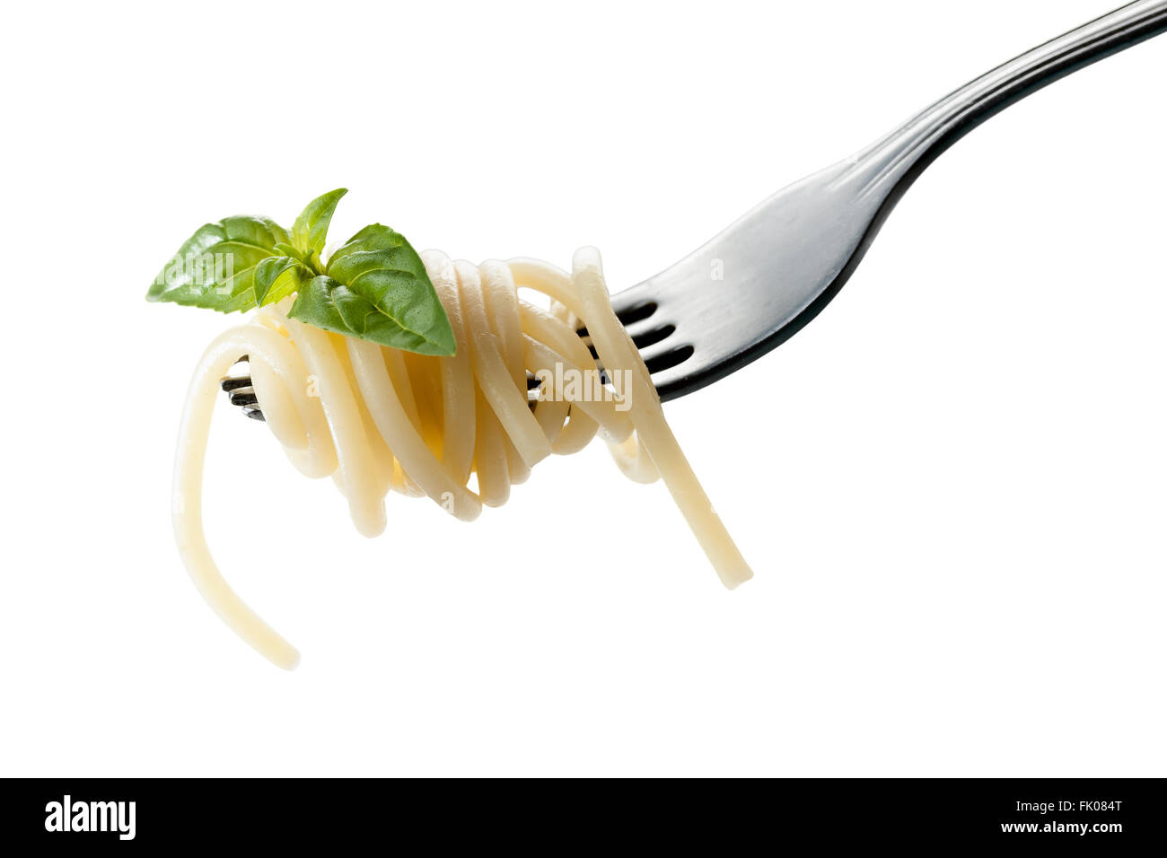 Pasta on a fork with basil Stock Photo