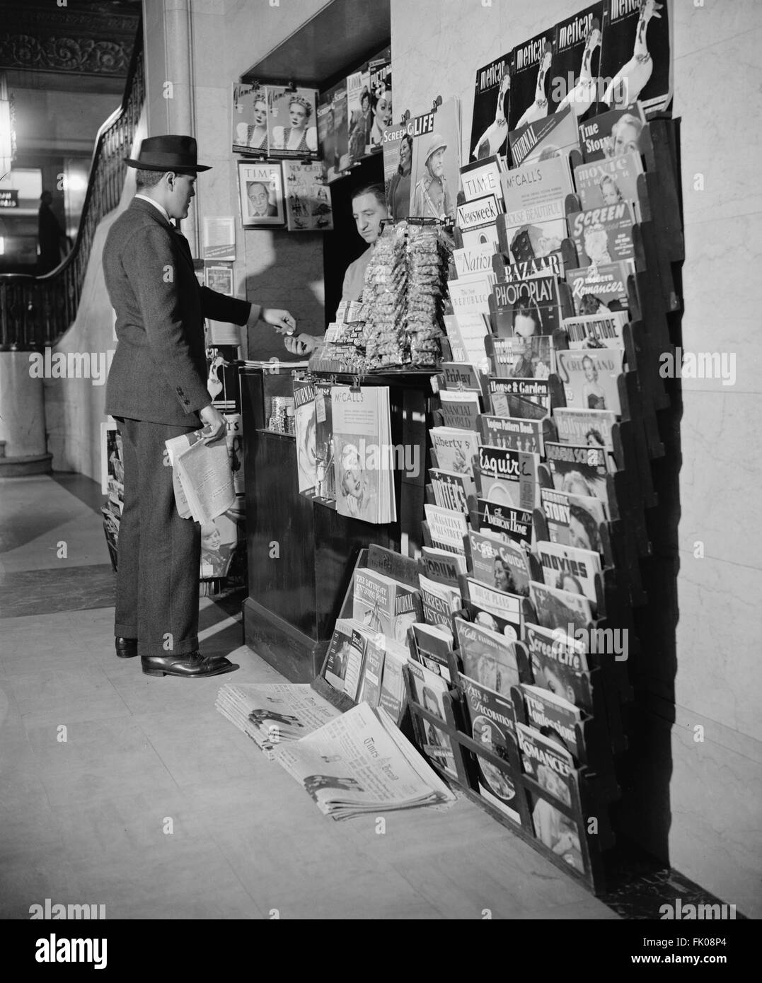 Man Buying Newspaper at Newsstand, Washington DC, USA, circa 1940.jpg Stock Photo
