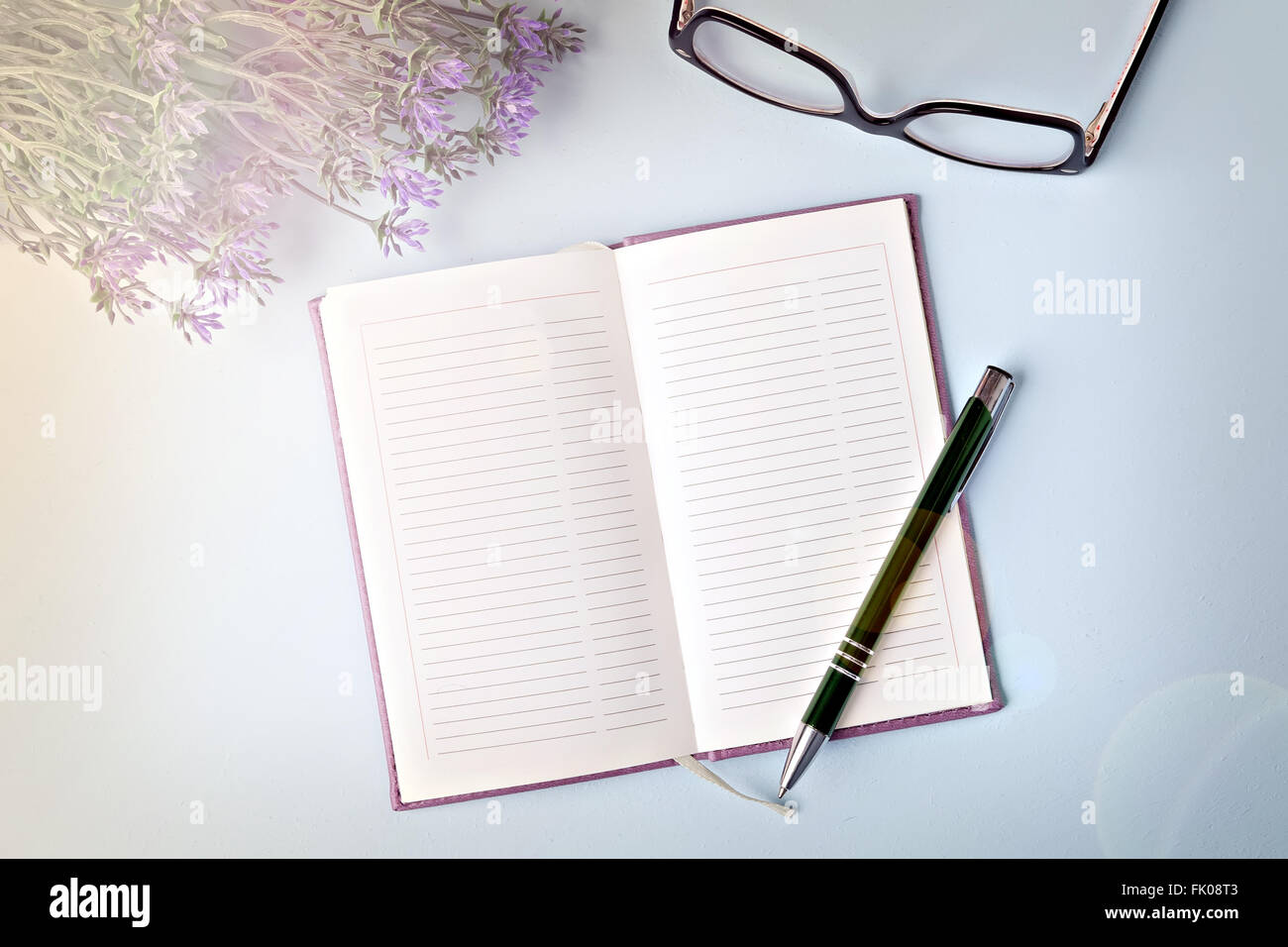 opened notebook with pen on blue table, flat lay Stock Photo - Alamy