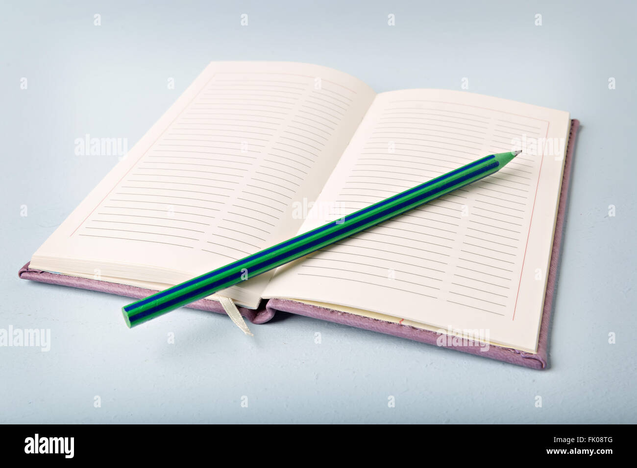 opened notebook on blue table, flat lay Stock Photo
