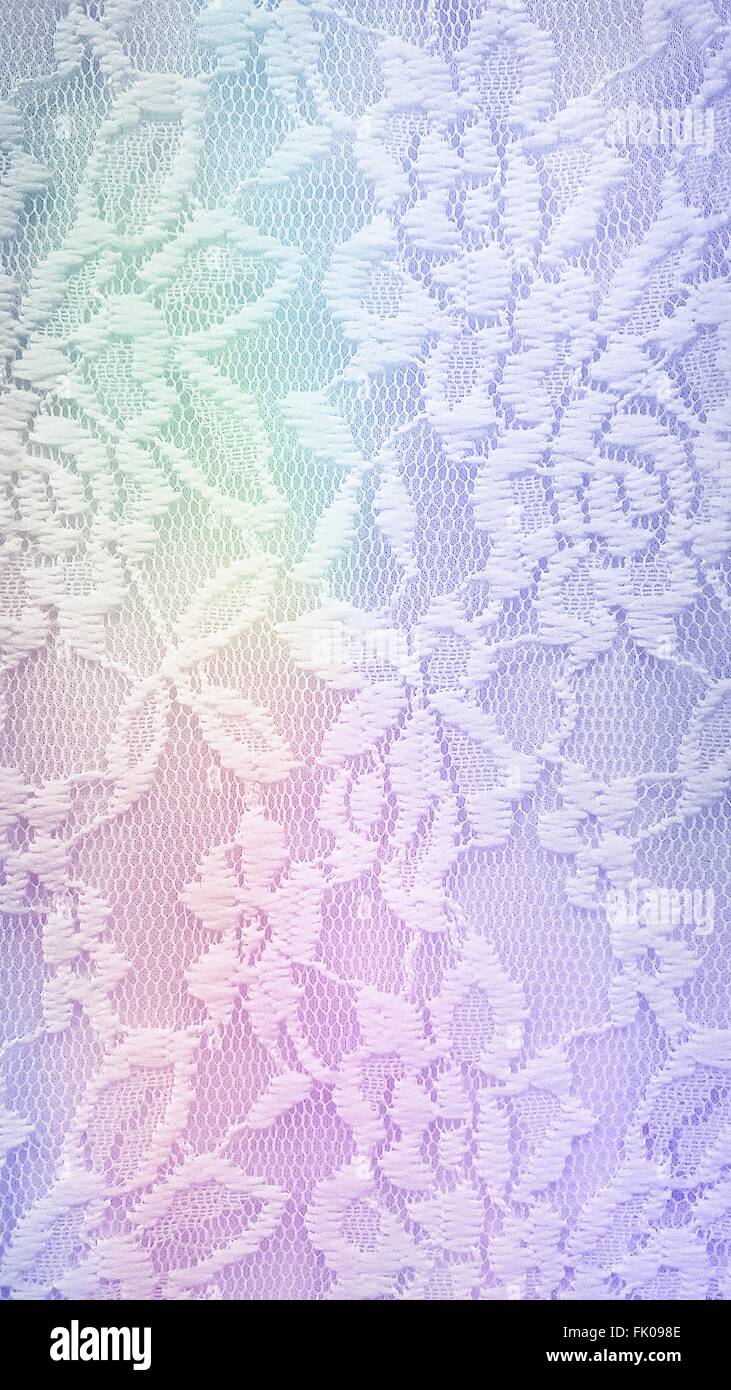 Close up of lace fabric with rainbow spectrum. Stock Photo