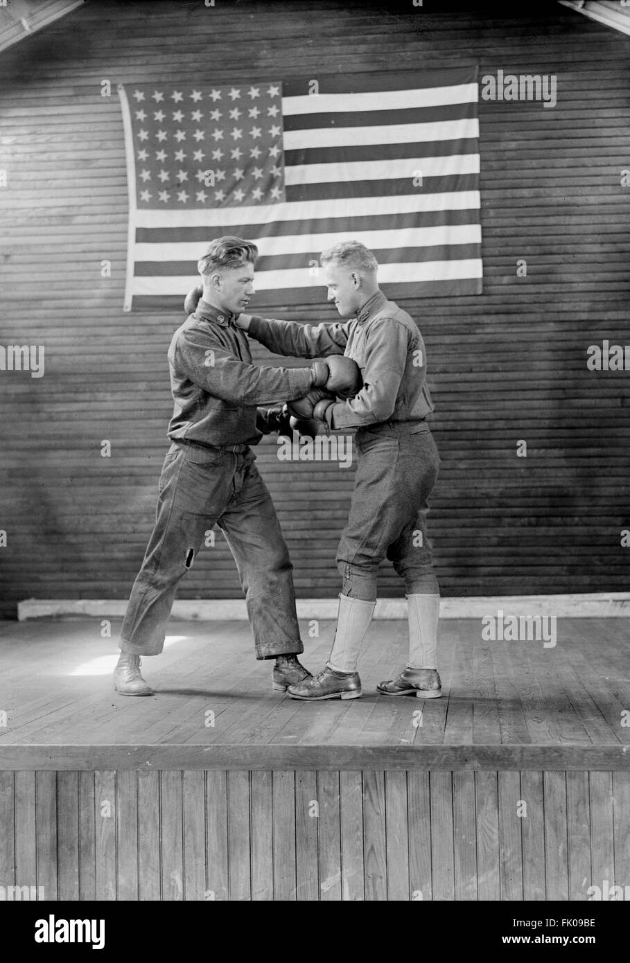 Two Military Men Boxing at Training Camp with American Flag in Background, USA, circa 1918 Stock Photo