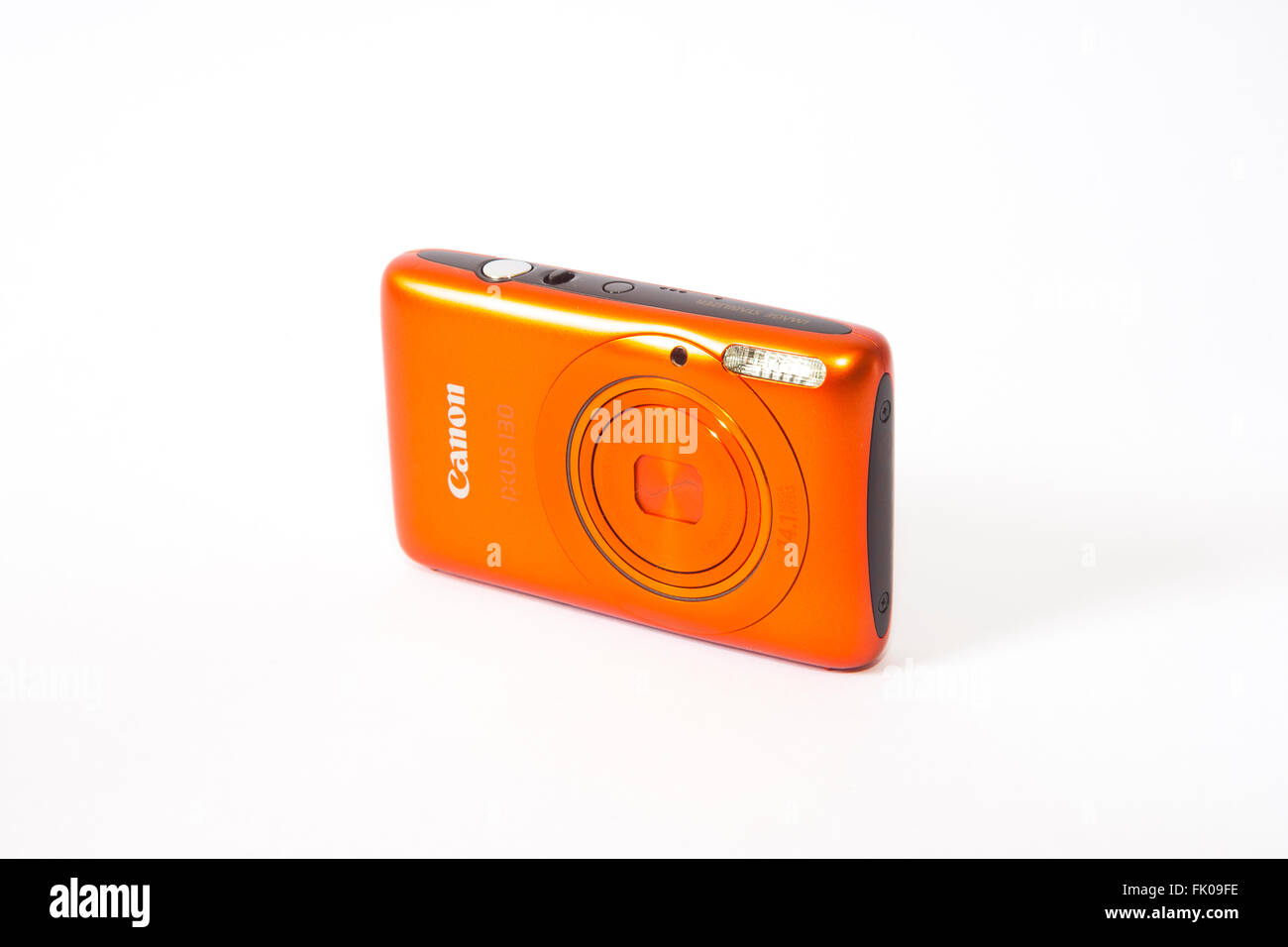 Canon Ixus 130 in orange compact camera turned off. Stock Photo
