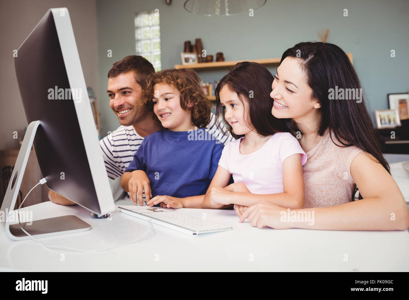 Close-up of happy family looking in computer Stock Photo - Alamy
