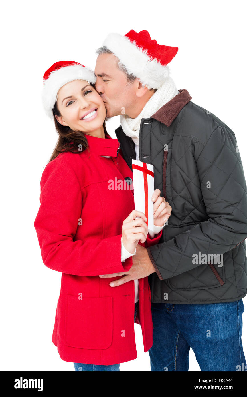 Festive couple exchanging christmas gift Stock Photo