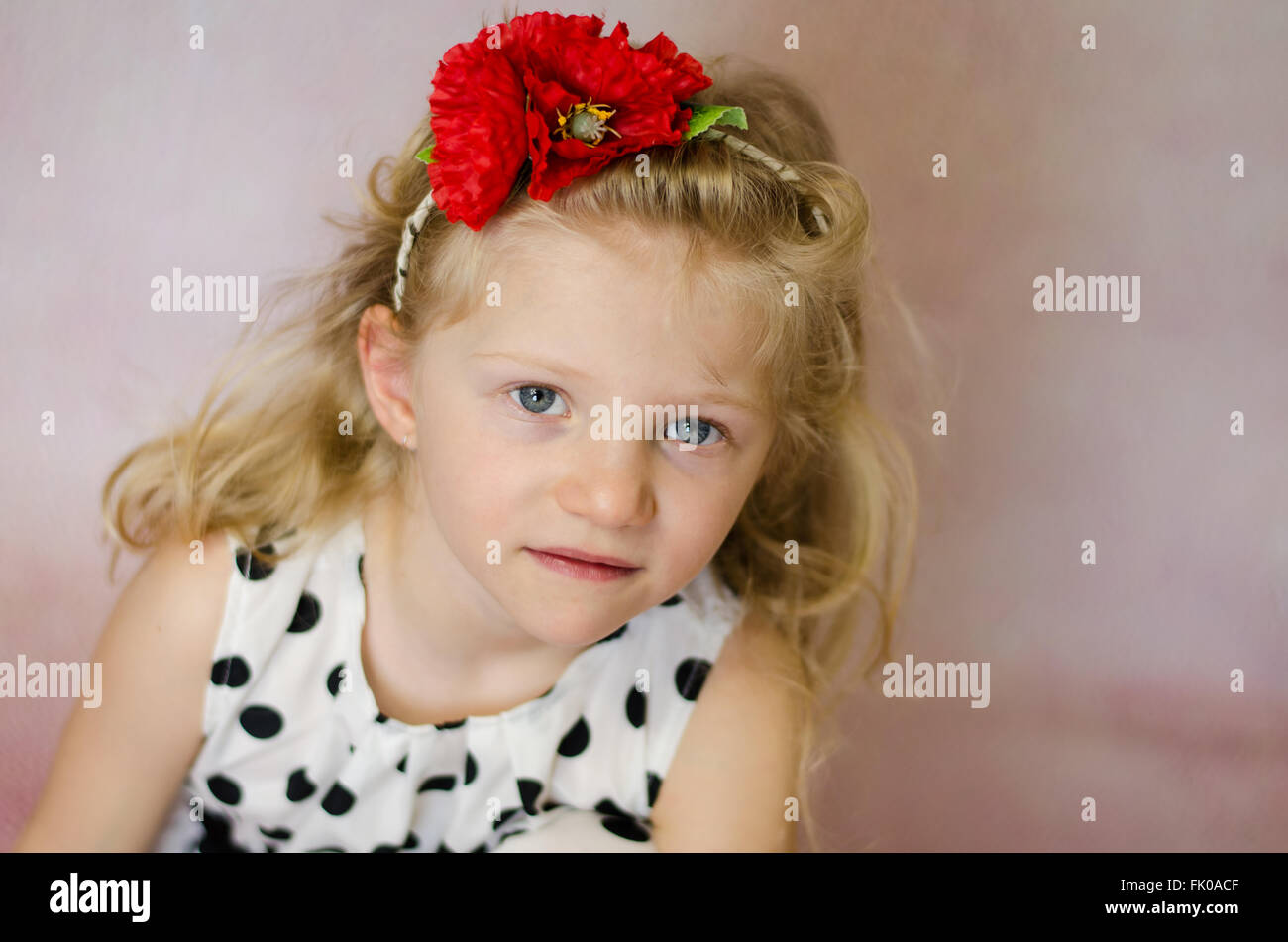 portrait of girl with corn rose in hair and long blond hair Stock Photo