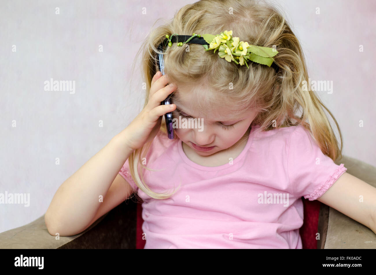 blond girl listening to someone in mobile phone Stock Photo Alamy
