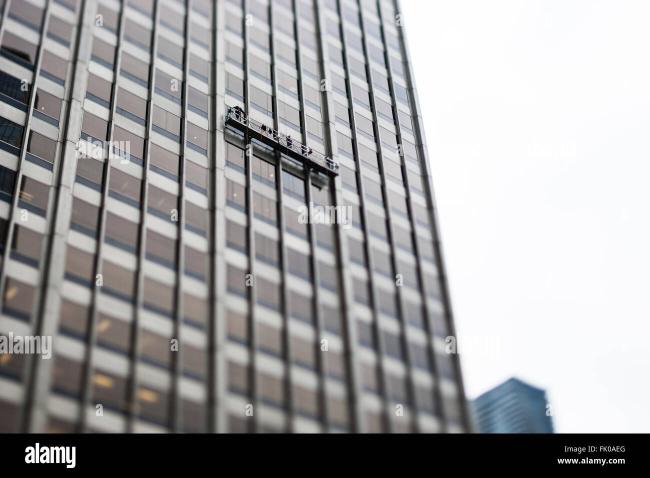 Chicago, Illinois, USA. Window cleaners on a suspended gantry working on the side of a