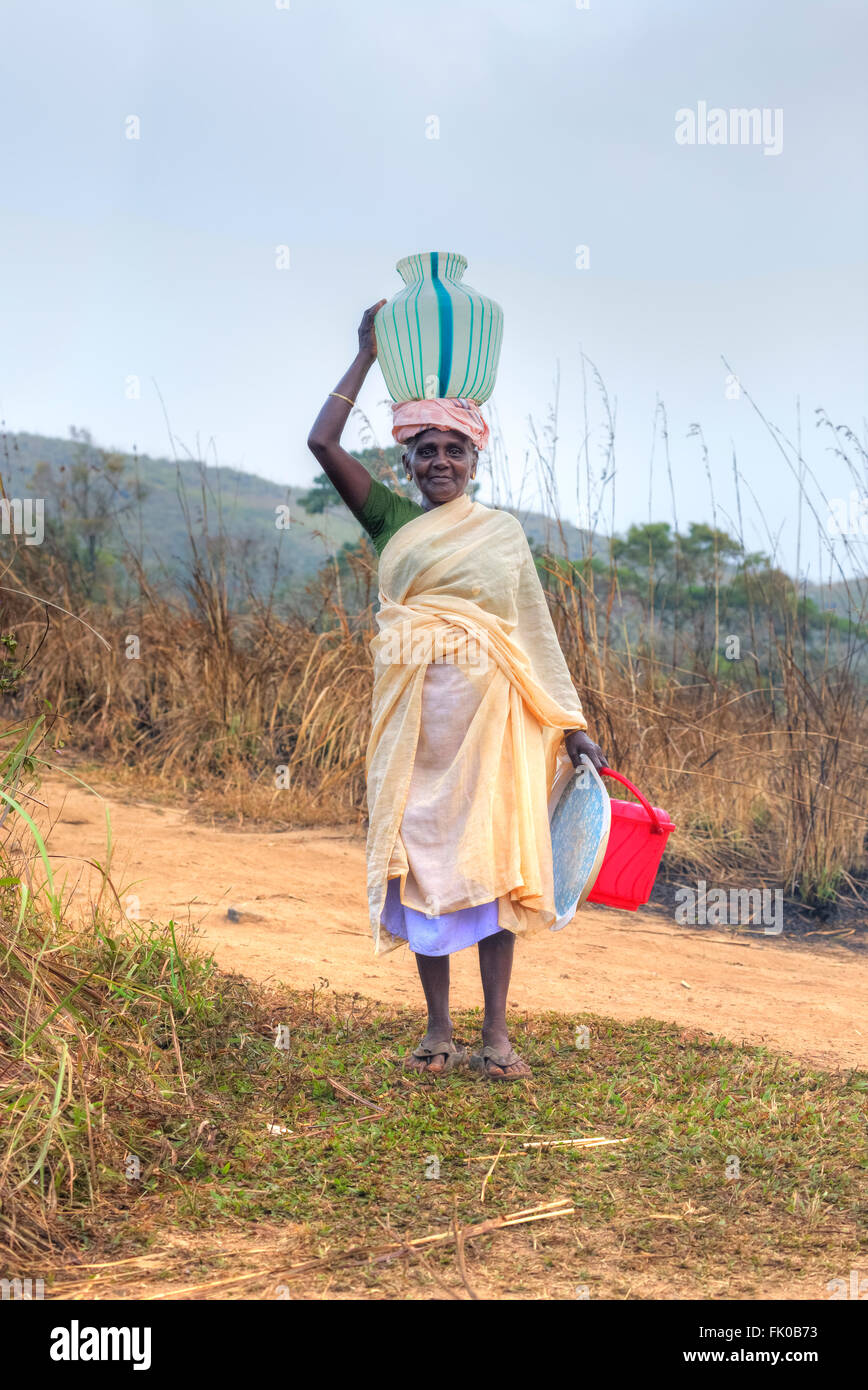 traditional woman carrying water in Periyar, Thekkady, Kerala, India Stock Photo
