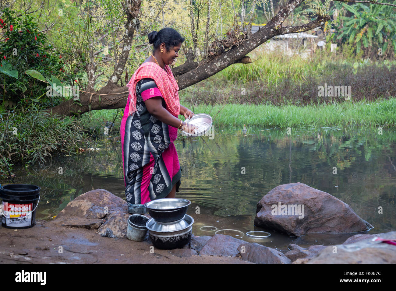 woman washing the dishes in Periyar, Kerala, India Stock Photo