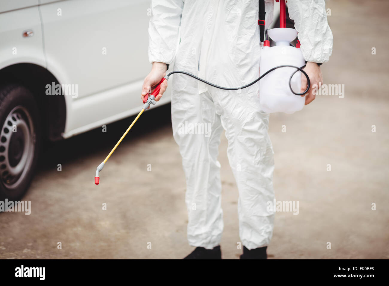 Handyman with insecticide Stock Photo