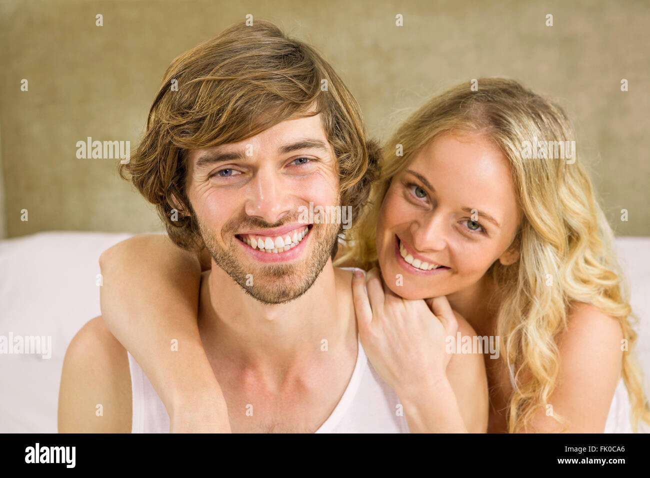 Cute couple cuddling on their bed Stock Photo Alamy