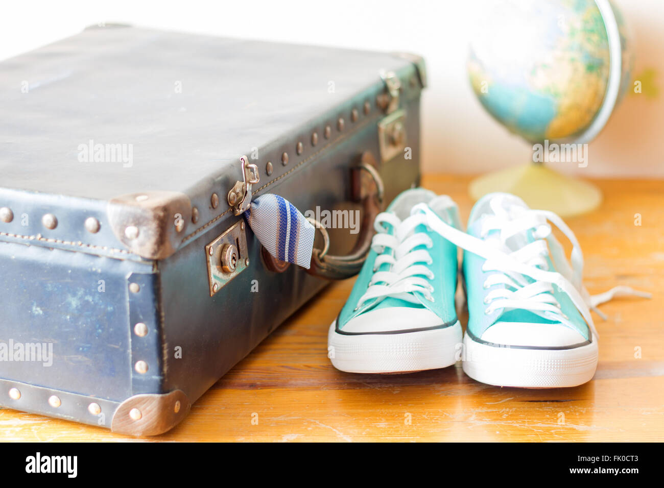 Travel concept with holiday suitcase, shoes and globe concept Stock Photo